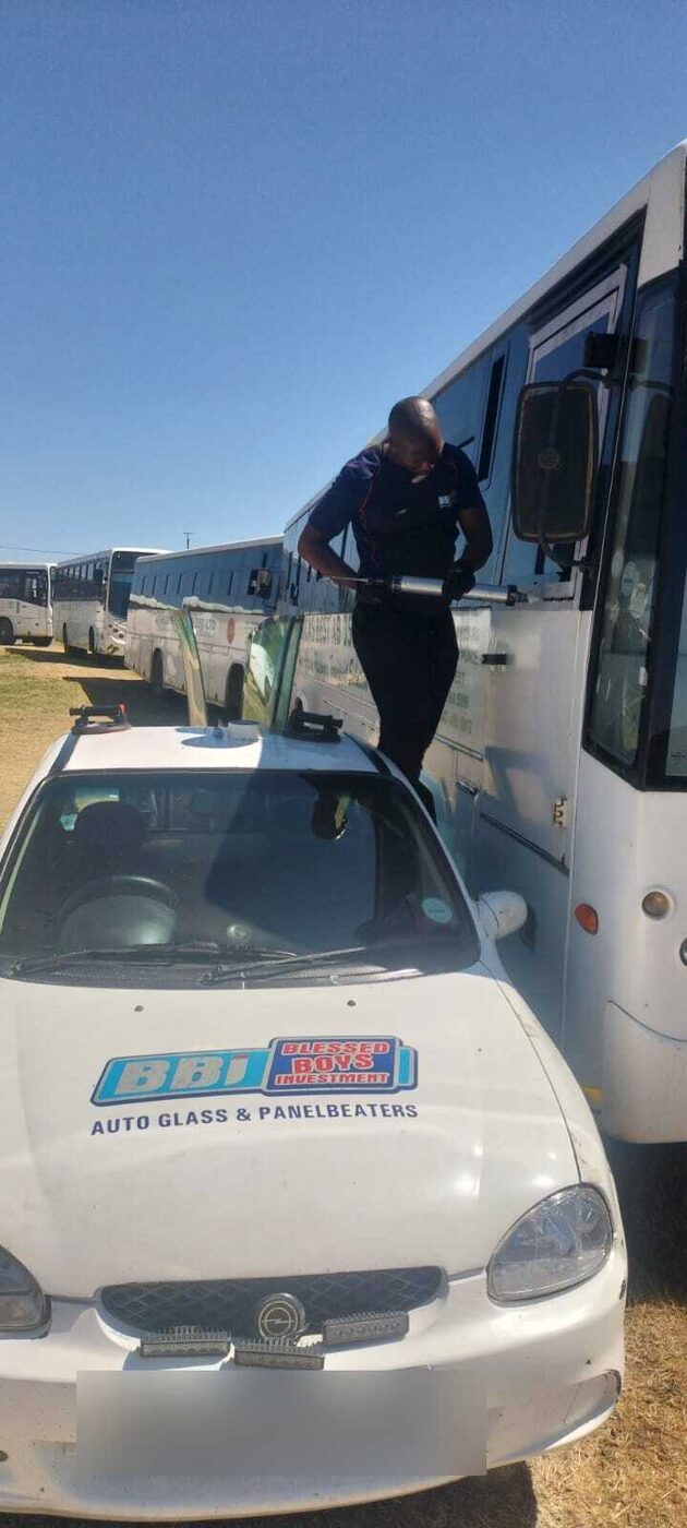 BBi technician fitting glass on a passenger bus